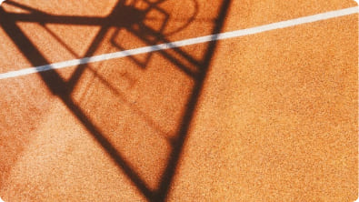 Person meditating in lotus position with silhouette against sunrise
