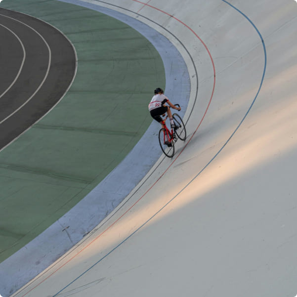 Cyclist riding bicycle along coastal road with ocean view