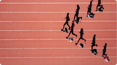 Group of runners training together in urban park at sunrise